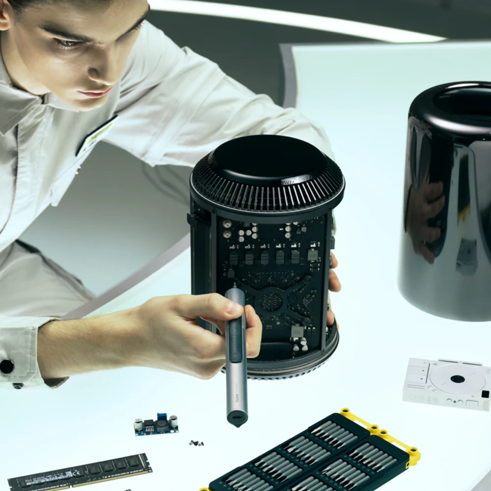 Person working on a computer component with tools on a table