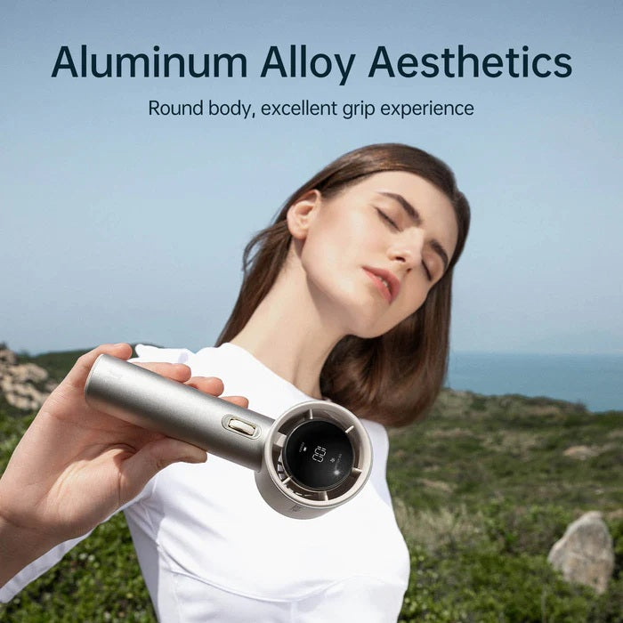 Person holding a metallic device with scenic background