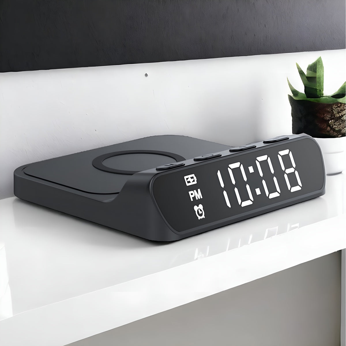 Black digital clock with wireless charging pad on a white surface