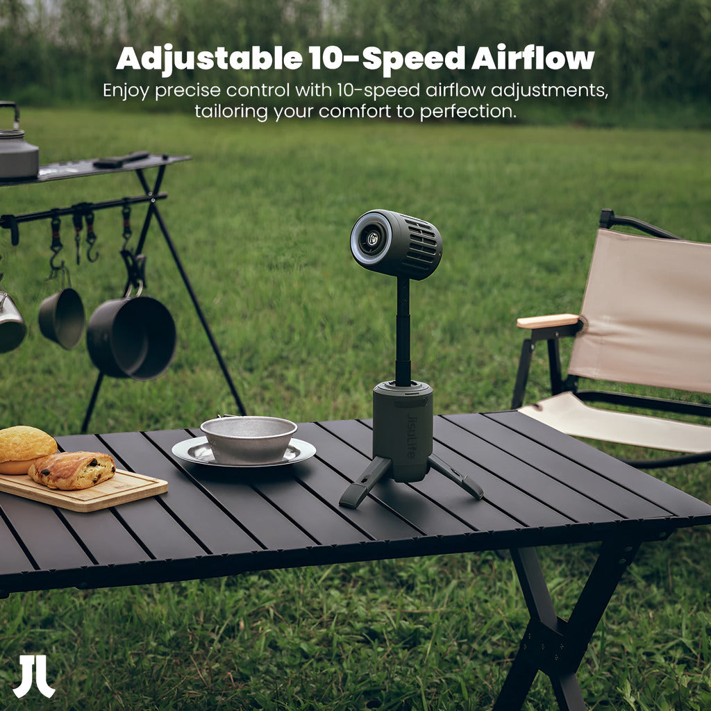 Portable air conditioner on a table outdoors with camping gear in the background