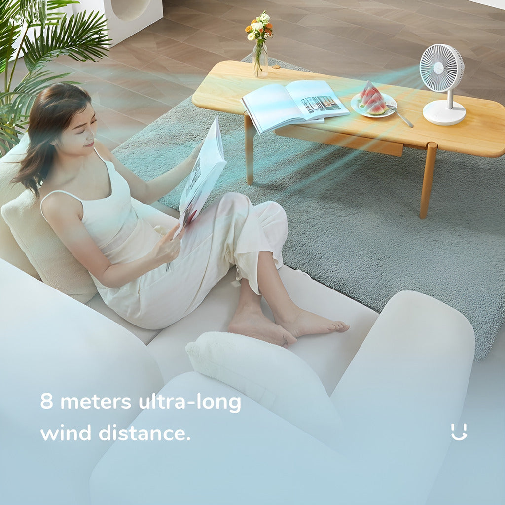 Woman reading a book on a couch with a small fan blowing air, indicating 8 meters of wind distance.
