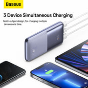 Baseus power bank with multiple devices charging on a white background