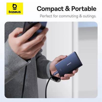 Person holding a compact electronic device with 'baseus' branding, labeled as 'Compact & Portable'.