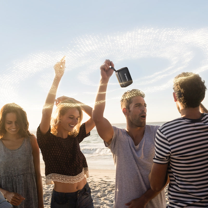 Group of friends enjoying time together on a beach with a clear sky.