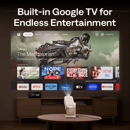 Aurzen Boom Air Portable 1080p Google TV Projector Smart TV with Google TV interface displaying various apps in a home entertainment setup.