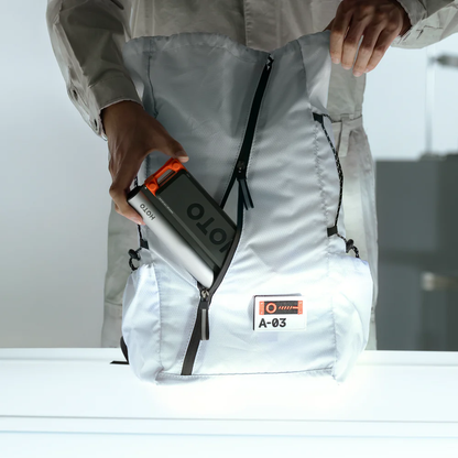 Person holding a portable power station labeled 'ION' against a white background