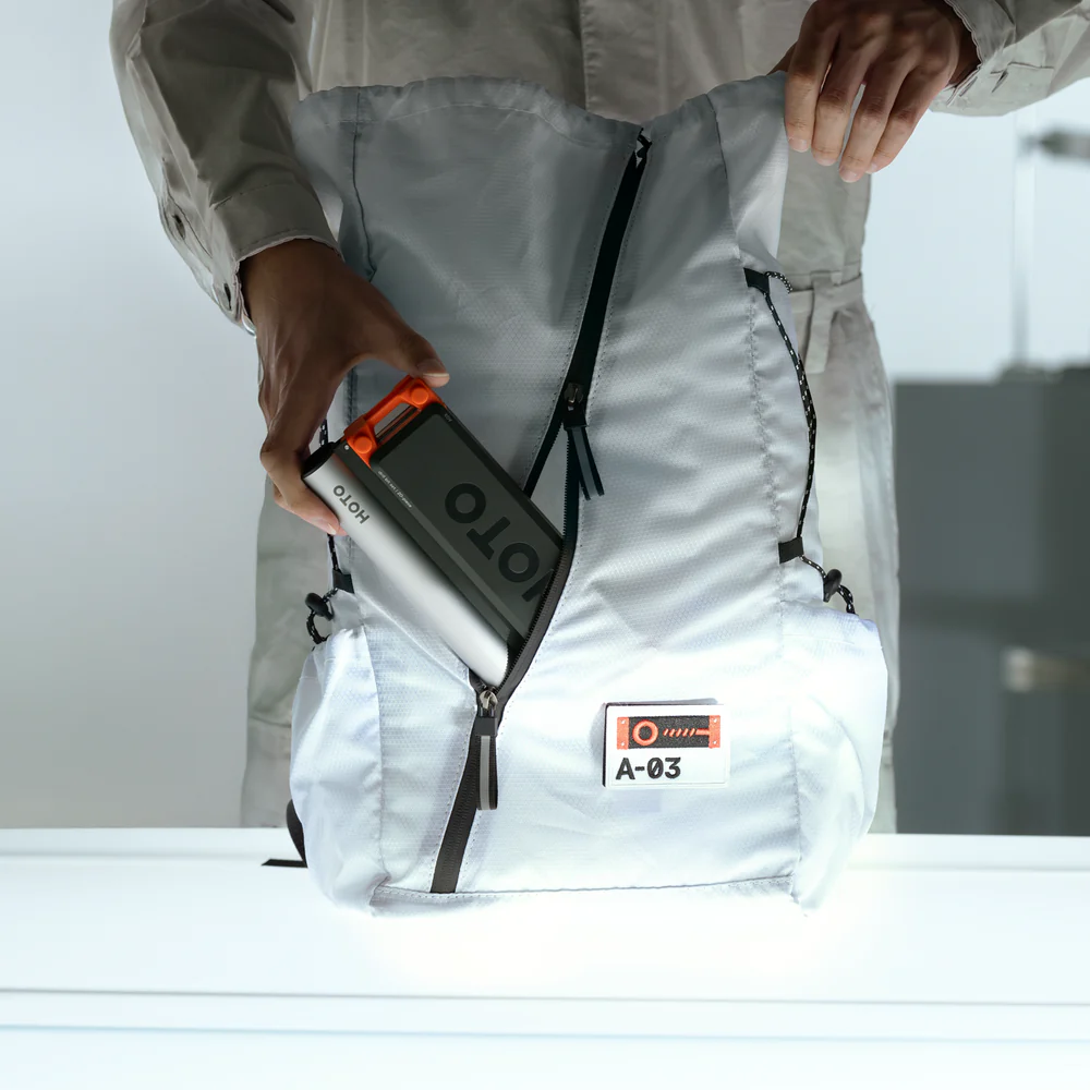 Person holding a portable power station labeled 'ION' against a white background