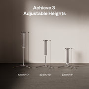 Three adjustable height stands with labeled dimensions against a plain wall.