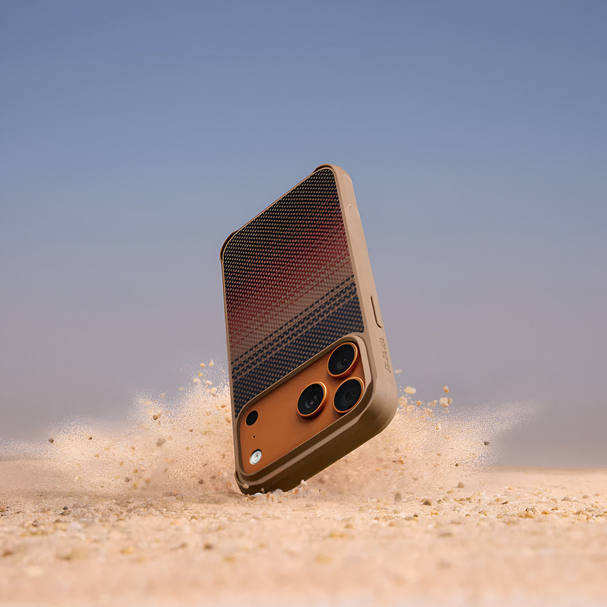 PITAKA ProGaurd Aramid Fibre Case for iPhone 17 Pro Max Phone case being thrown in the air with a desert background