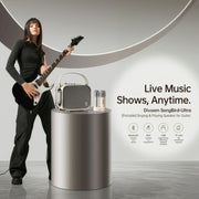 A woman holding a black electric guitar stands beside a silver cylindrical pedestal displaying a portable Bluetooth speaker and two microphones. The background is a clean studio setting with a large circular architectural element, and text on the right reads 'Live Music Shows, Anytime.