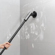 HOTO Cordless Spin Scrubber 6 Brush Head Set Person using a long-handled cleaning tool on a tiled wall