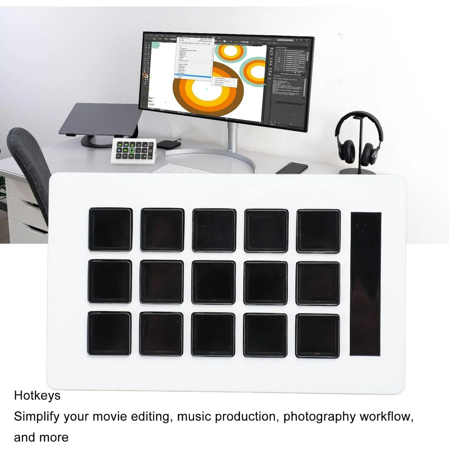 Desk setup with computer monitor, keyboard, and headphones on a white desk.