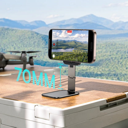 Smartphone mounted on a stand with a scenic view in the background