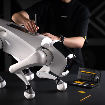 Person assembling a white robotic dog with tools on a dark surface