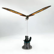 Model of a dragon on a stand with a white background