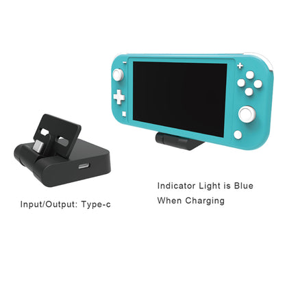 Turquoise handheld gaming device with charging dock on a white background
