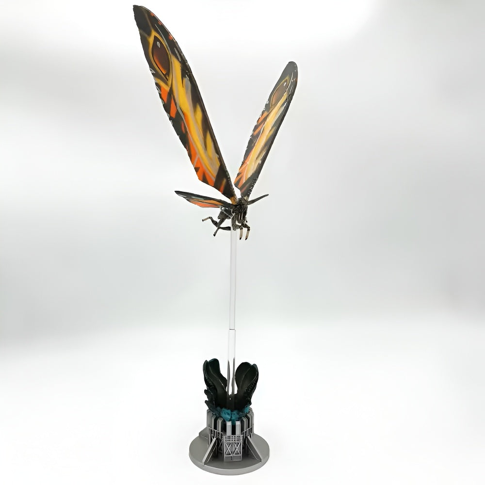Decorative item with butterfly wings on a stand against a white background