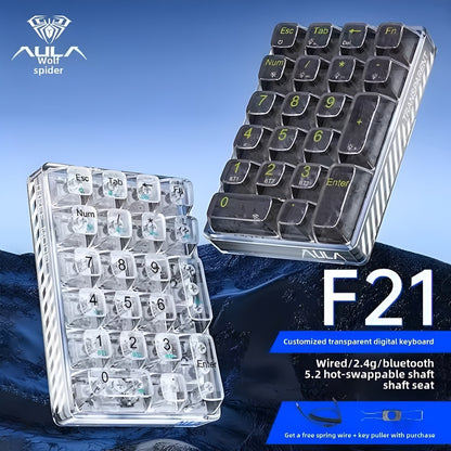 Two keyboards, one transparent and one with black keys, on a blue gradient background with AULA branding.