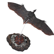 Decorative item resembling a winged creature with a fiery core on a white background