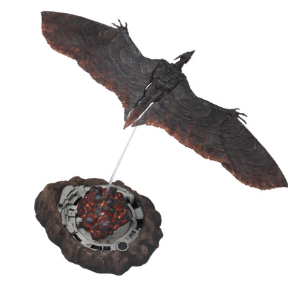 Decorative item resembling a winged creature with a fiery core on a white background