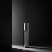 HOTO Flashlight Fit 280 Lumens Rechargeable Torch Silver electronic device on a dark surface with a dark background