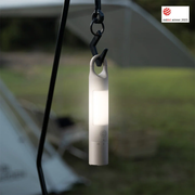 HOTO Flashlight Duo 1000 Lumens Dual-Light Rechargeable Torch Portable light hanging from a hook with a blurred outdoor background