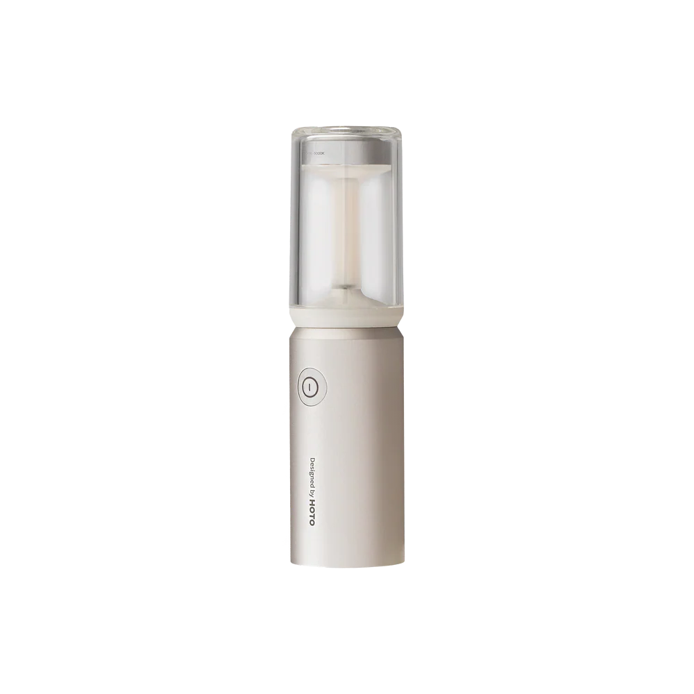 HOTO Camplight, Portable humidifier with a clear top and beige body on a white background