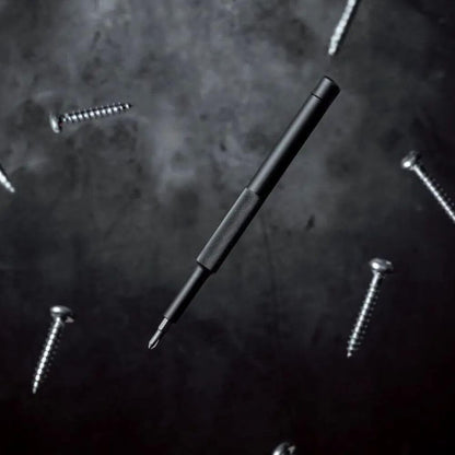 Black screwdriver on a dark textured surface with screws around it