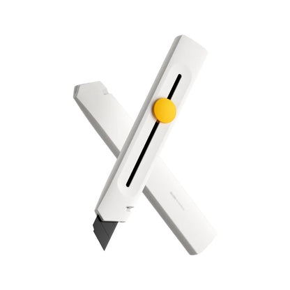 White cutter with a yellow button on a white background