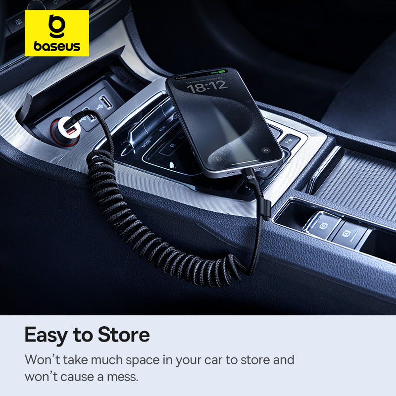 Baseus car charger in a car's USB port with a smartphone on top, displayed in a dark car interior.