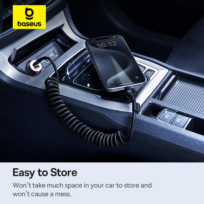 Baseus car charger in a car's USB port with a smartphone on top, displayed in a dark car interior.