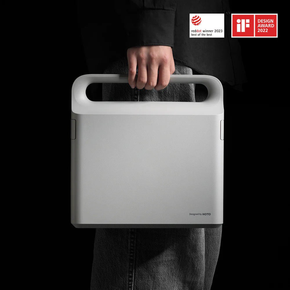 HOTO 12V Brushless Drill Tool Set, Person holding a white carrying case with design awards on a black background