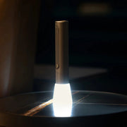 HOTO Flashlight Fit 280 Lumens Rechargeable Torch Handheld light device emitting a beam of light on a dark surface