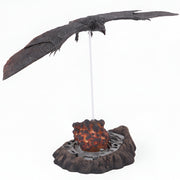 Decorative model of a dragon with a glowing egg on a white background