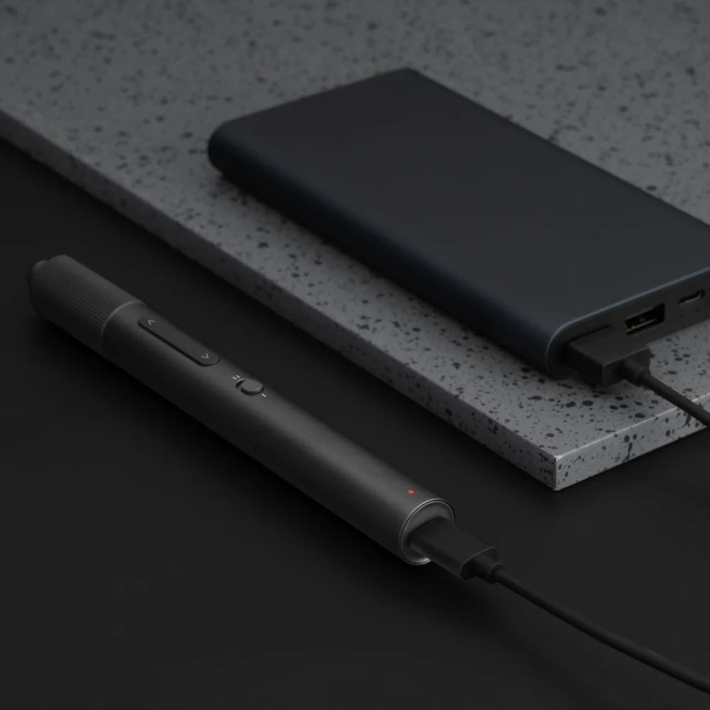 Black power bank and pen on a dark surface