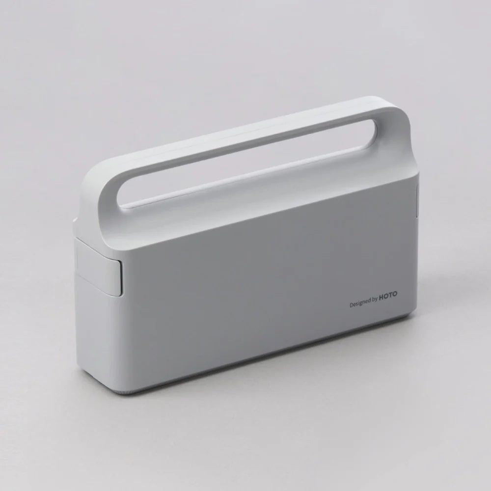 Gray portable device with a handle on a light gray background