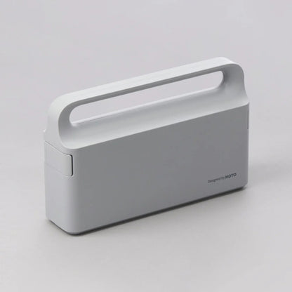 Gray portable device with a handle on a light gray background