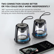 Two black and transparent speakers with blue LED lights on a white background, next to a smartphone.