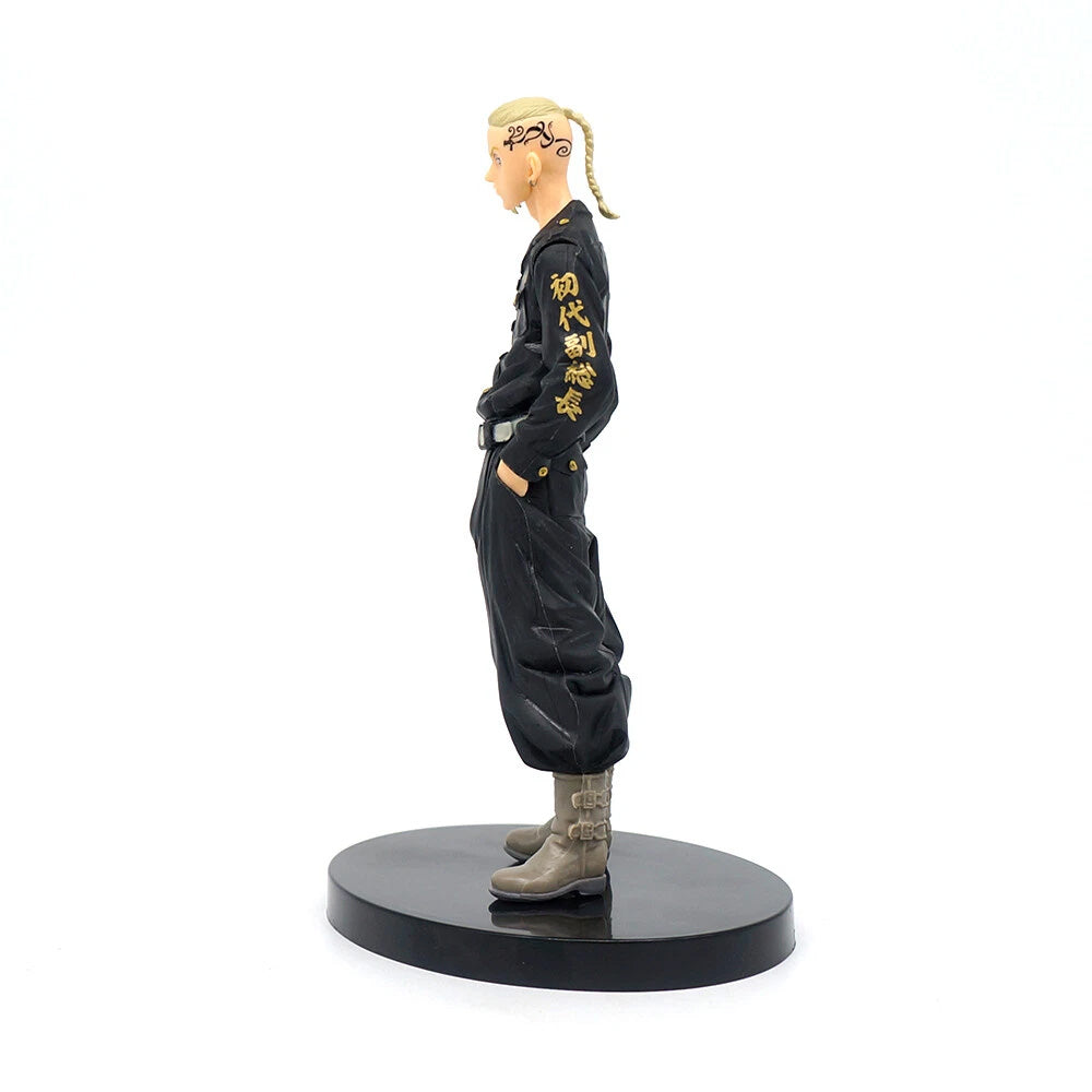 Figurine of a character in black outfit with yellow text on a white background