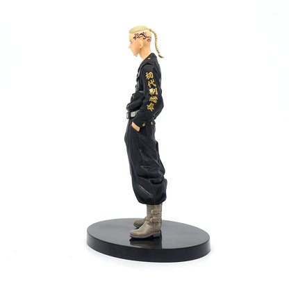 Figurine of a character in black outfit with yellow text on a white background