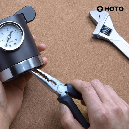 HOTO 12V Brushless Drill Tool Set, Person using a tool with a gauge on a corkboard background, featuring the brand 'HOTO'.