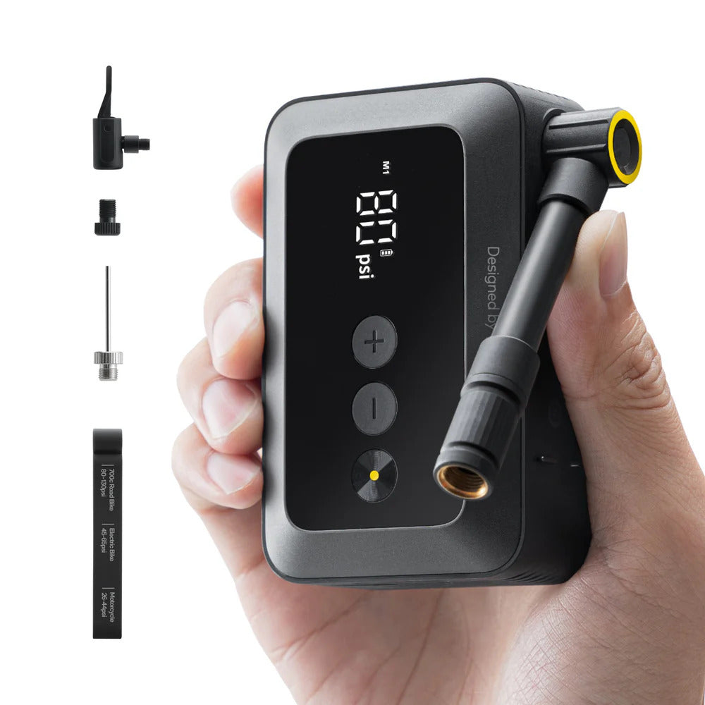 HOTO Air Pump Pocket, Hand holding a digital air pump with attachments on a white background