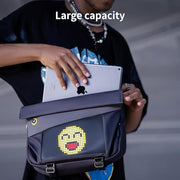 Divoom Pixoo Slingbag‑V Smart LED Sling Bag (4.7" Pixel Screen, App Control) Person holding a backpack with a digital emoji design, showing a large capacity.