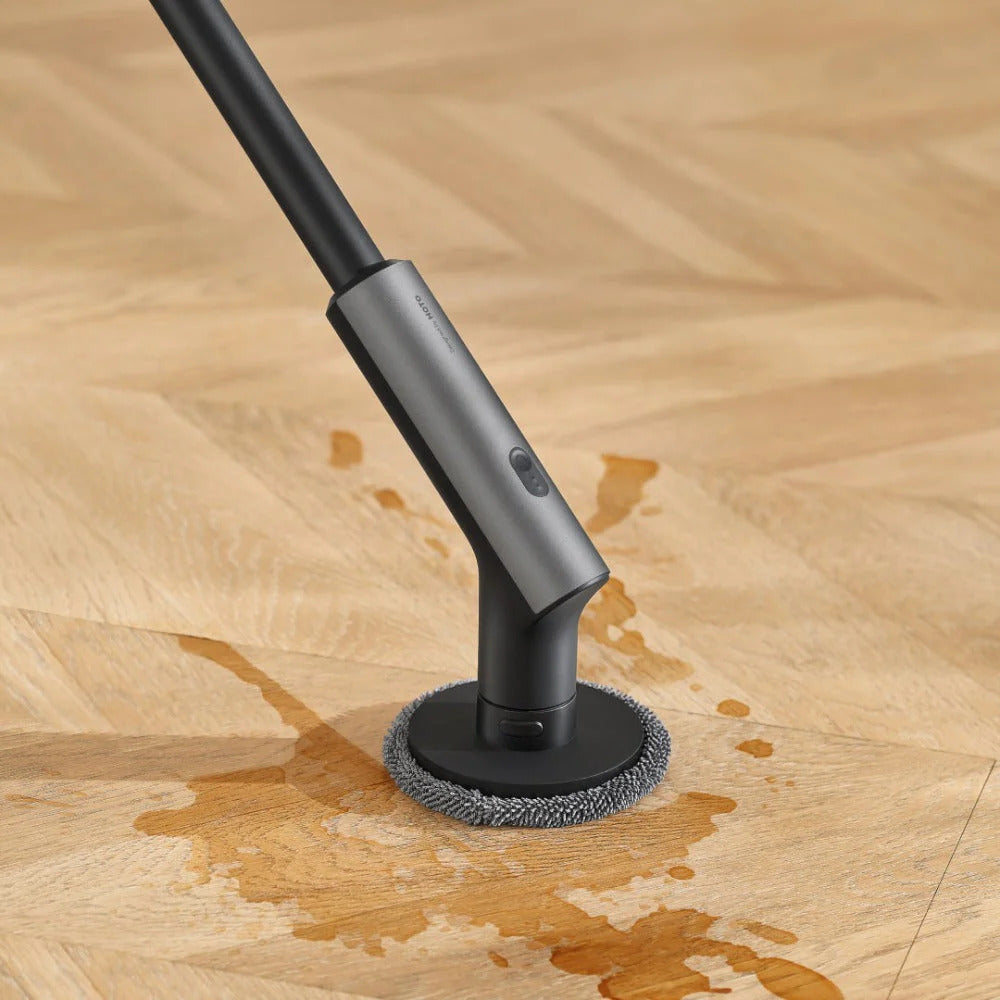 HOTO Cordless Spin Scrubber 6 Brush Head Set Cleaning tool with a brush head on a wooden floor
