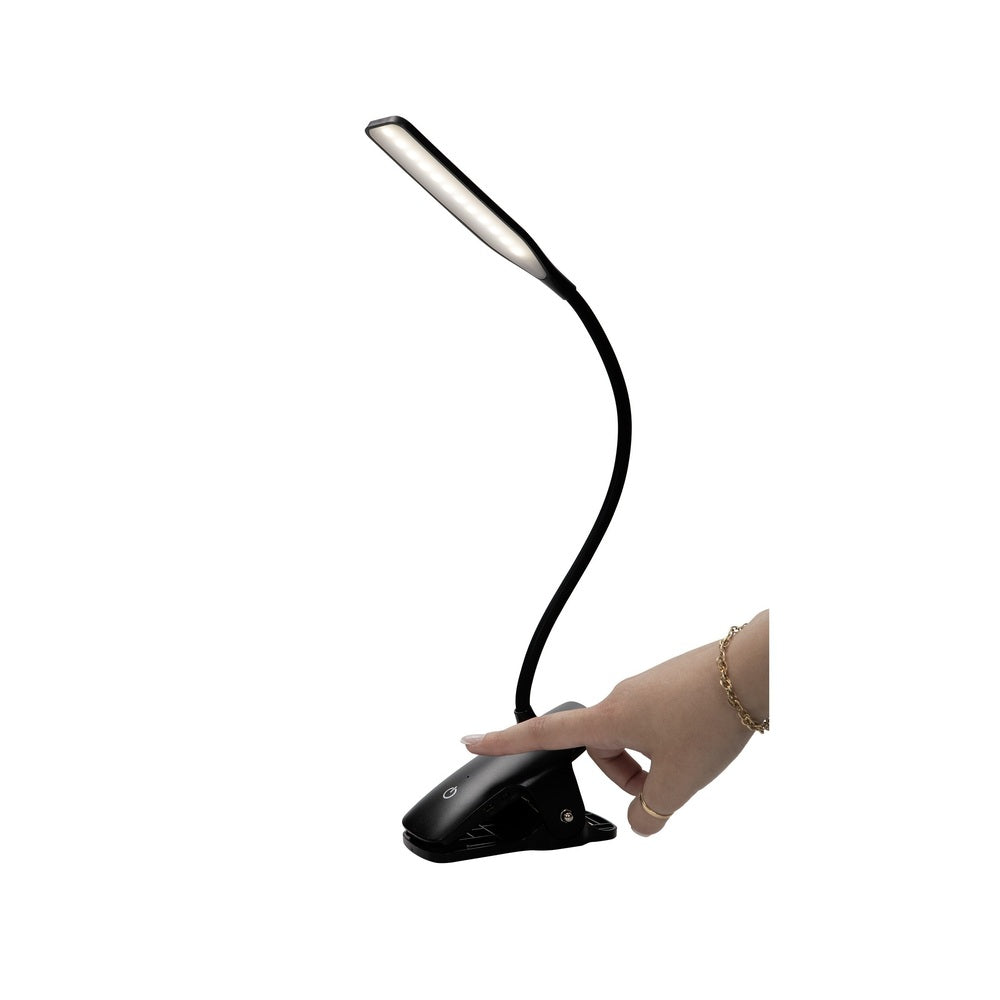 Black LED desk lamp with flexible neck held by a hand on a white background