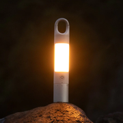 HOTO Flashlight Duo 1000 Lumens Dual-Light Rechargeable Torch Portable light on a rock with a dark background