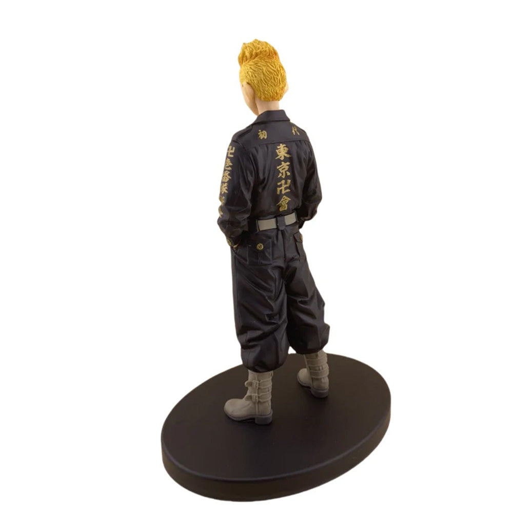 Figure of a character in a dark outfit with yellow hair on a white background