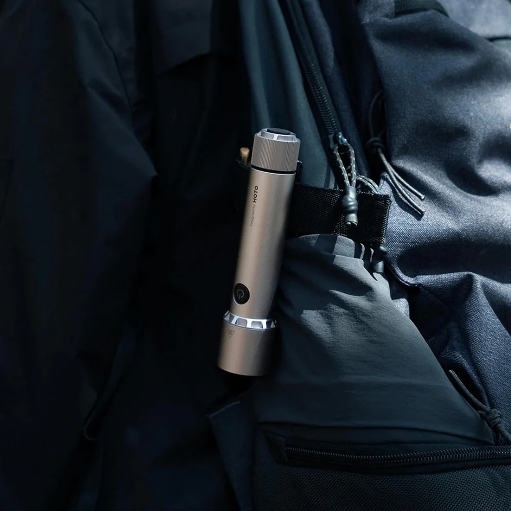HOTO Flashlight Tactics 2300 Tactical Rechargeable Torch Silver flashlight held against a dark background