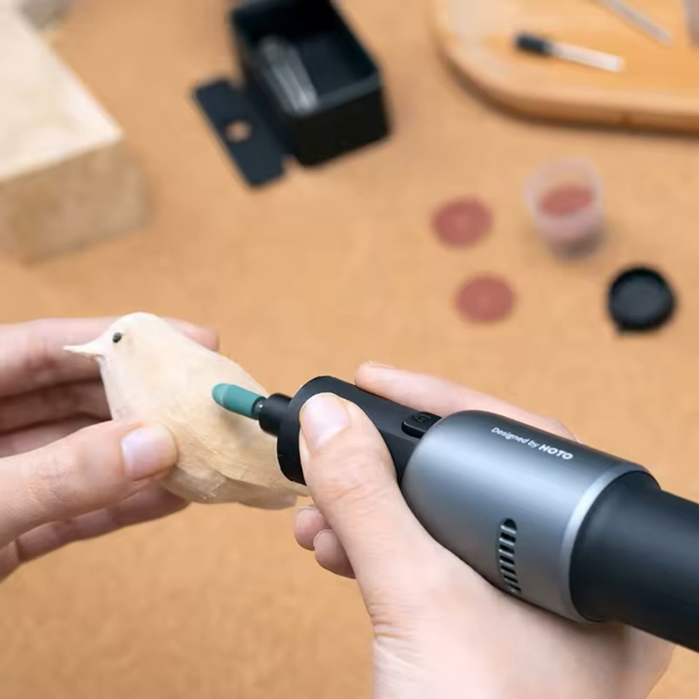 HOTO Rotary Tool Accessories Kit 60 Piece Set ,Person using a rotary tool on a wooden object with a blurred workshop background