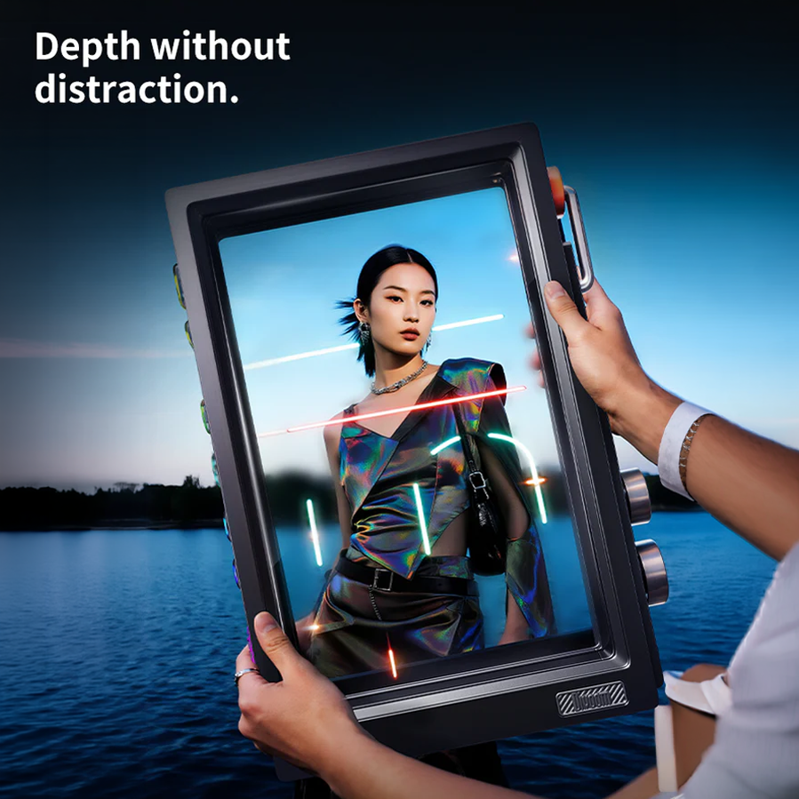 Divoom Times Frame 10.1" Transparent Smart Display (64GB, Wi‑Fi 6, RGB Lighting) Person holding a futuristic device displaying an image of a woman with a scenic background.